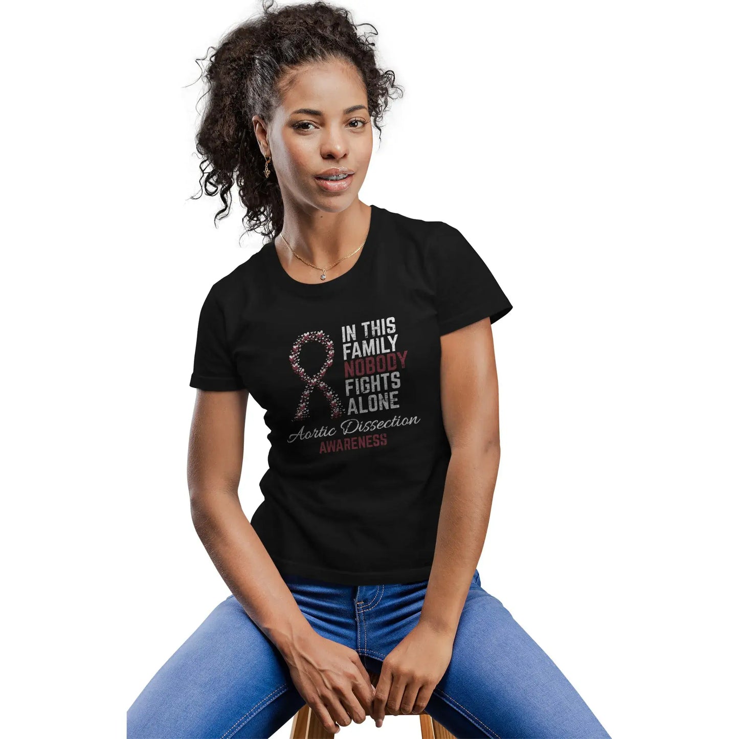 A woman models the Aortic Dissection Awareness shirt featuring the quote “In This Family No One Fights Alone” to honor recovery and raise awareness.
