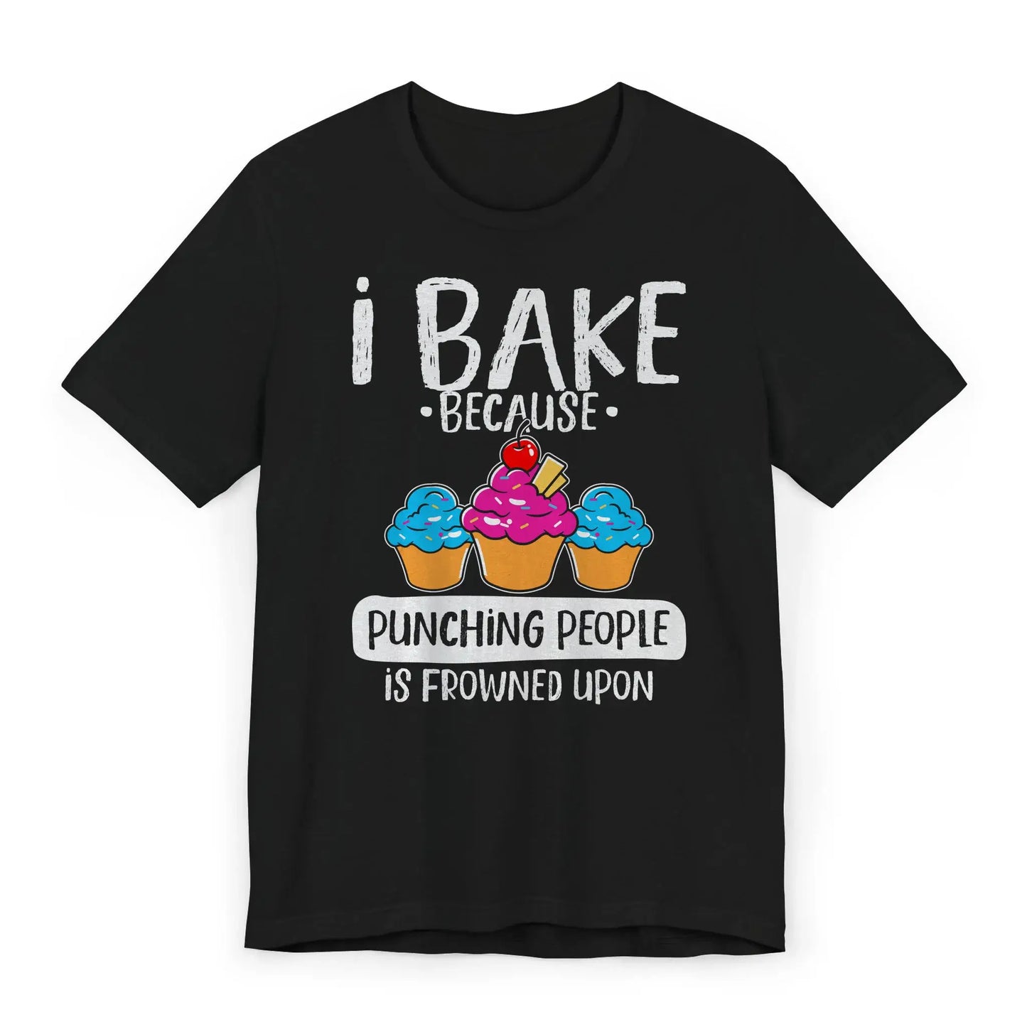 Flat lay of T-shirt with pink whisk and text I Bake Because Punching People Is Frowned Upon