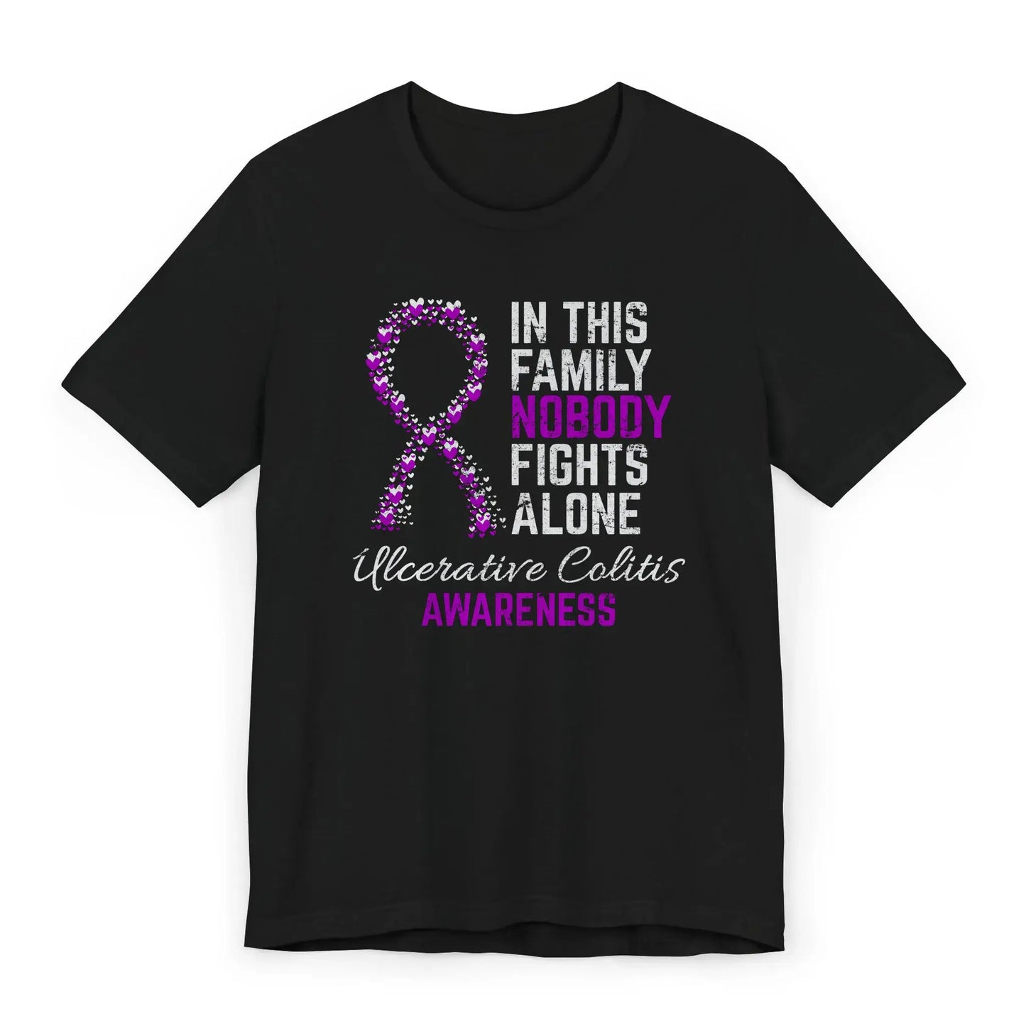 Flat image of the ulcerative colitis awareness T-shirt with a heart-filled ribbon and the quote “In This Family No One Fights Alone.”