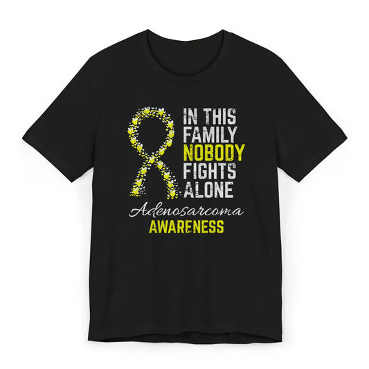 Flat image of the adenosarcoma awareness T-shirt featuring a heart-filled ribbon and the quote “In This Family No One Fights Alone.”