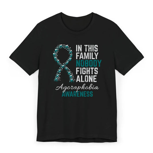 Flat image of the agoraphobia awareness T-shirt with a heart-filled ribbon and the quote “In This Family No One Fights Alone.”