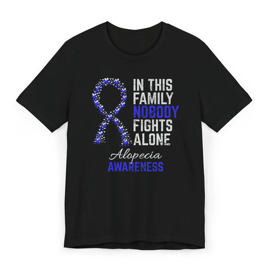 Flat image of the alopecia awareness T-shirt with a heart-filled ribbon and the quote “In This Family No One Fights Alone.”