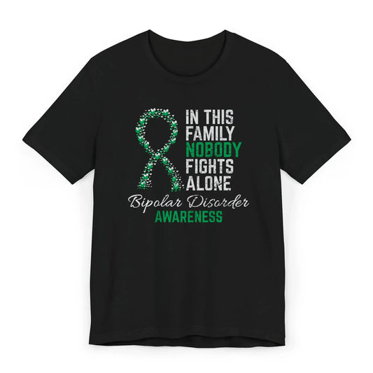 Flat image of the bipolar disorder awareness T-shirt featuring a heart-filled ribbon and the quote “In This Family No One Fights Alone.”