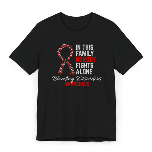 The flat lay shows the bleeding disorders awareness unisex T-shirt with a heart-filled ribbon and quote to support clotting disorder fighters.