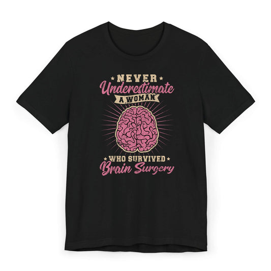 Flat lay of women’s brain surgery survivor shirt with quote “Never Underestimate a Woman Who Survived Brain Surgery.”