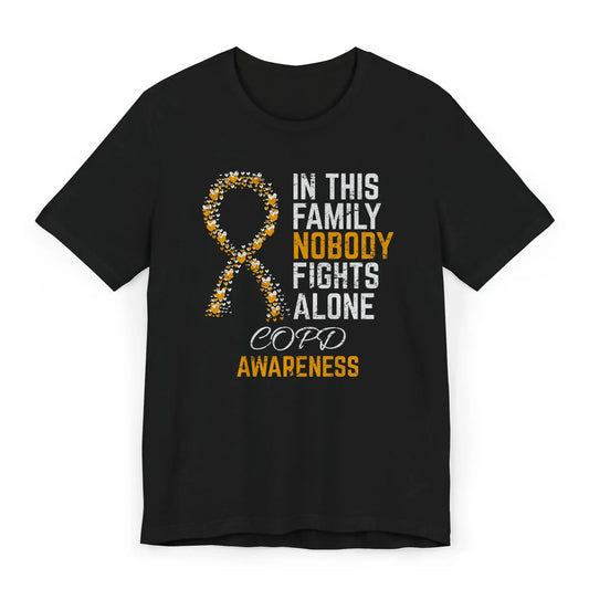 Flat image of the COPD awareness T-shirt with a heart-filled ribbon and the quote “In This Family No One Fights Alone.”