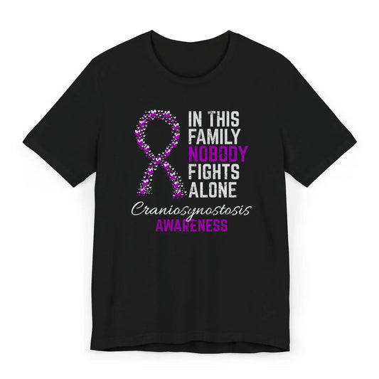 Flat image of the craniosynostosis awareness T-shirt with a heart-filled ribbon and the quote “In This Family No One Fights Alone.”