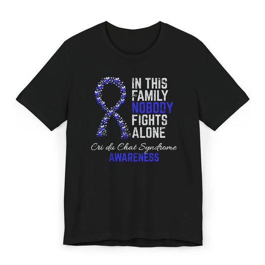 The flat image shows a Cri du Chat syndrome awareness unisex T-shirt with a heart-filled ribbon and quote supporting rare disease visibility and strength.