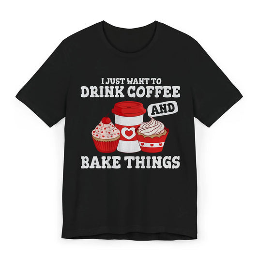 Flat lay of black shirt with cupcakes and text I Just Want to Drink Coffee and Bake Things