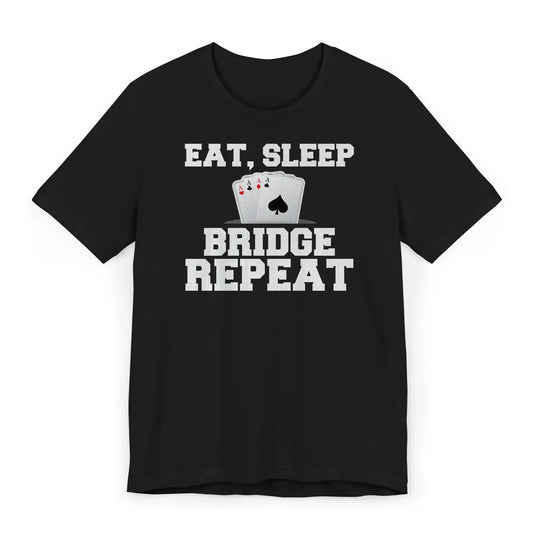 Flat lay of bridge player shirt with quote “Eat Sleep Bridge Repeat” and card graphic.