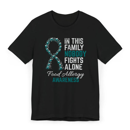 Flat image of the food allergy awareness T-shirt with a heart-filled ribbon and the quote “In This Family No One Fights Alone.”