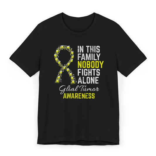 Flat image of the glial tumor awareness T-shirt with a heart-filled ribbon and the quote “In This Family No One Fights Alone.”