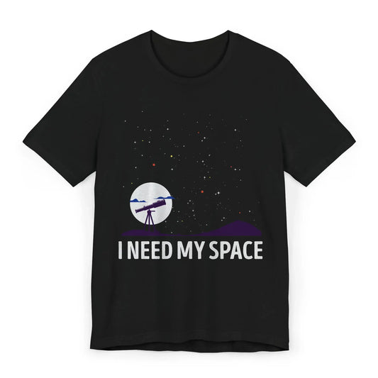 Flatlay of I Need My Space shirt with telescope and stars