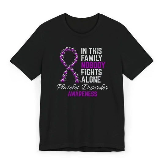Flat image of the platelet disorder awareness T-shirt with a heart-filled ribbon and the quote “In This Family No One Fights Alone.”