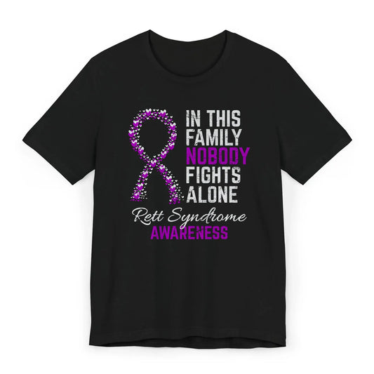 Flat image of the Rett syndrome awareness T-shirt with a heart-filled ribbon and the quote “In This Family No One Fights Alone.”
