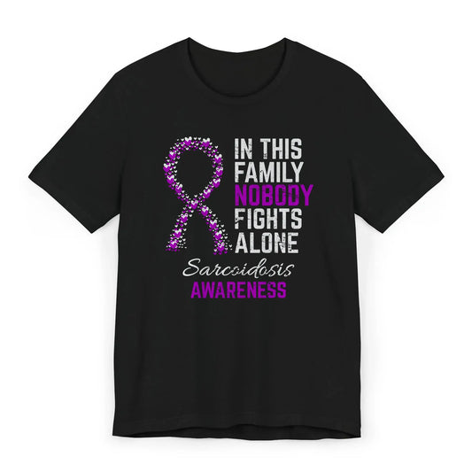 Flat image of the sarcoidosis awareness T-shirt with a heart-filled ribbon and the quote “In This Family No One Fights Alone.”