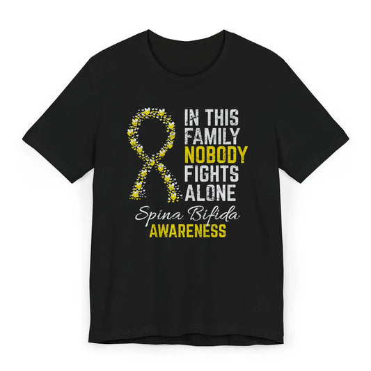 The flat image shows a Spina Bifida Awareness T-shirt with a heart-filled yellow ribbon and quote supporting strength and resilience from birth.