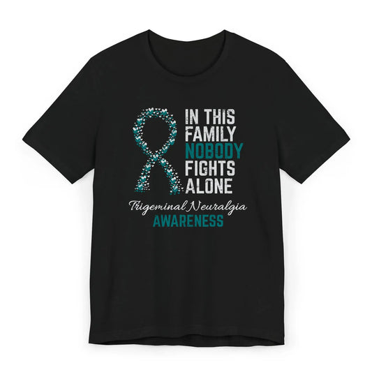 Flat image of the trigeminal neuralgia awareness T-shirt with a heart-filled ribbon and the quote “In This Family No One Fights Alone.”